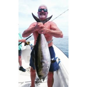 man holding fish from deep sea fishing